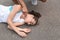 Young man checking pulse of  woman on street