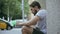 Young man checking smartphone outdoors