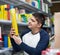 Young man choosing insects killer spray