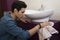 Young man cleaning bathroom wiping the basin and cabinets