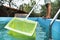 Young man cleaning a swimming pool