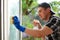 Young Man Cleaning Windows. Window washer.