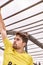 Young man climbing an iron ladder in a Spartan race