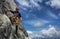 Young man climbing on a rock in Swiss Alps