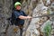 Young man climbing on via ferrata