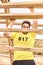 Young man climbing a wooden ladder in a Spartan race