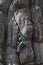 Young man climbs on a cliff with a rope.