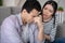 Young man with closed eyes and sympathetic woman.