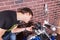 Young Man Closely Examining Gauges on Motorcycle