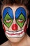 Young man in clown makeup