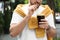 Young man with cold kvass outdoors, closeup. Traditional Russian summer drink