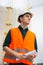 Young man in construction in orange vest