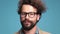 Young man with curly hair anf long beard and mustache