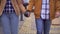 Young man with a cyber prosthetic arm holds the hand of his beloved close up