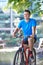 Young Man Cycling Next To River In Urban Setting