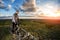 Young man cycling on a rural road through meadow