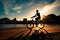 Young Man Cycling Silhouette by Sunset