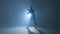 Young man dancer dancing funky hip hop on isolated studio neon blue background, slow motion