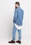 Young man in denim suit. Handsome man in denim jacket and jeans on a white background. Photo for advertising men`s jeans