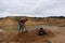 A young man digs a hole with a shovel