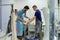 Young man with disability helping his colleague measuring plaster cast diameter