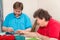 Young man and disabled woman are knitting together