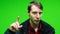 Young man disapproving with NO hand sign make negation finger gesture on green screen background.