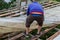 Young man Dismantling Old corrugated polycarbonate roof on the village house