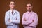 Young man doctor and man patient against brown background