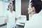 Young Man with Doctor in White Coat in Clinic.