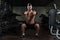 Young Man Doing Exercise Dumbbell Squat