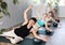 Young man doing pilates exercises with softball under arm in training area