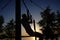 Young man doing pull ups on horizontal bar outdoors during sunset - fitness, sport, exercising, training and lifestyle