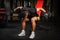 Young man doing Seated Bent Over Dumbbell Reverse