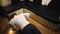 Young man doing sports at home near the sofa, doing push-ups with weighting from the floor