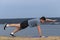 Young man doing yoga outside in natural environment