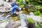 Young man drinking water from a spring.