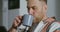 Young man drinks coffee without taking his eyes off screen of a mobile phone