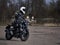 Young man drive with motorbike on street, enjoying freedom and active lifestyle, having fun on a bikers tour