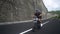 Young man drives on custom motorbike on beatiful road