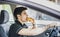 Young man driving his car while eating food