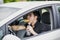 Young man driving his car while eating food