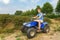 Young man driving quad in nature