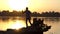 Young man in earphones dances at a golden sunset in slo-mo