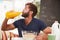 Young Man Eating Breakfast And Drinking Orange Juice