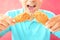Young man eating deep fried chicken legs or drumsticks