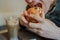 Young man is eating hamburger. A man is sitting at the table and eating a cheeseburger in fast food cafe.