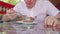 A young man is eating an Indian meat dish in a tropical cafe.