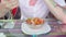 A young man is eating an Indian meat dish in a tropical cafe.