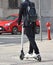 Young man with an electric roller on the road